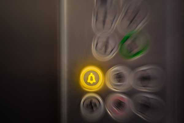 Alarm button on elevator control panel. Emergency concept.